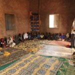 Abdullahi Elmi with MOH team member inside his classroom supporting efforts to promote vaccination among children