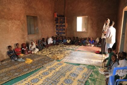 Abdullahi Elmi with MOH team member inside his classroom supporting efforts to promote vaccination among children